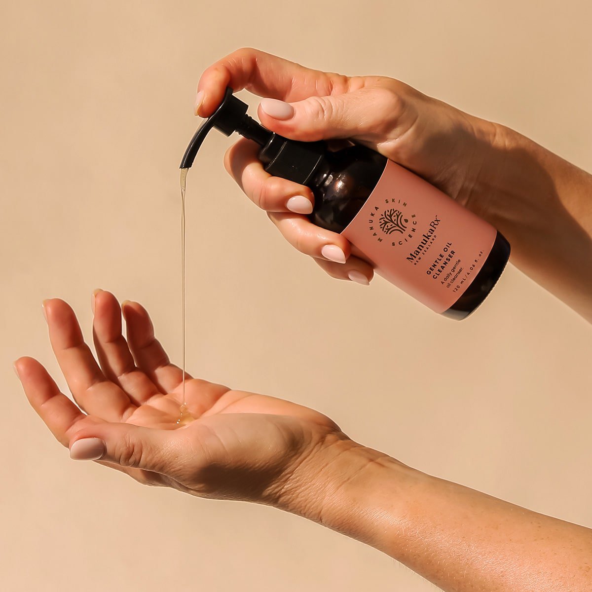 ManukaRx Gentle Oil Cleanser product pumped into palm of a woman's hand