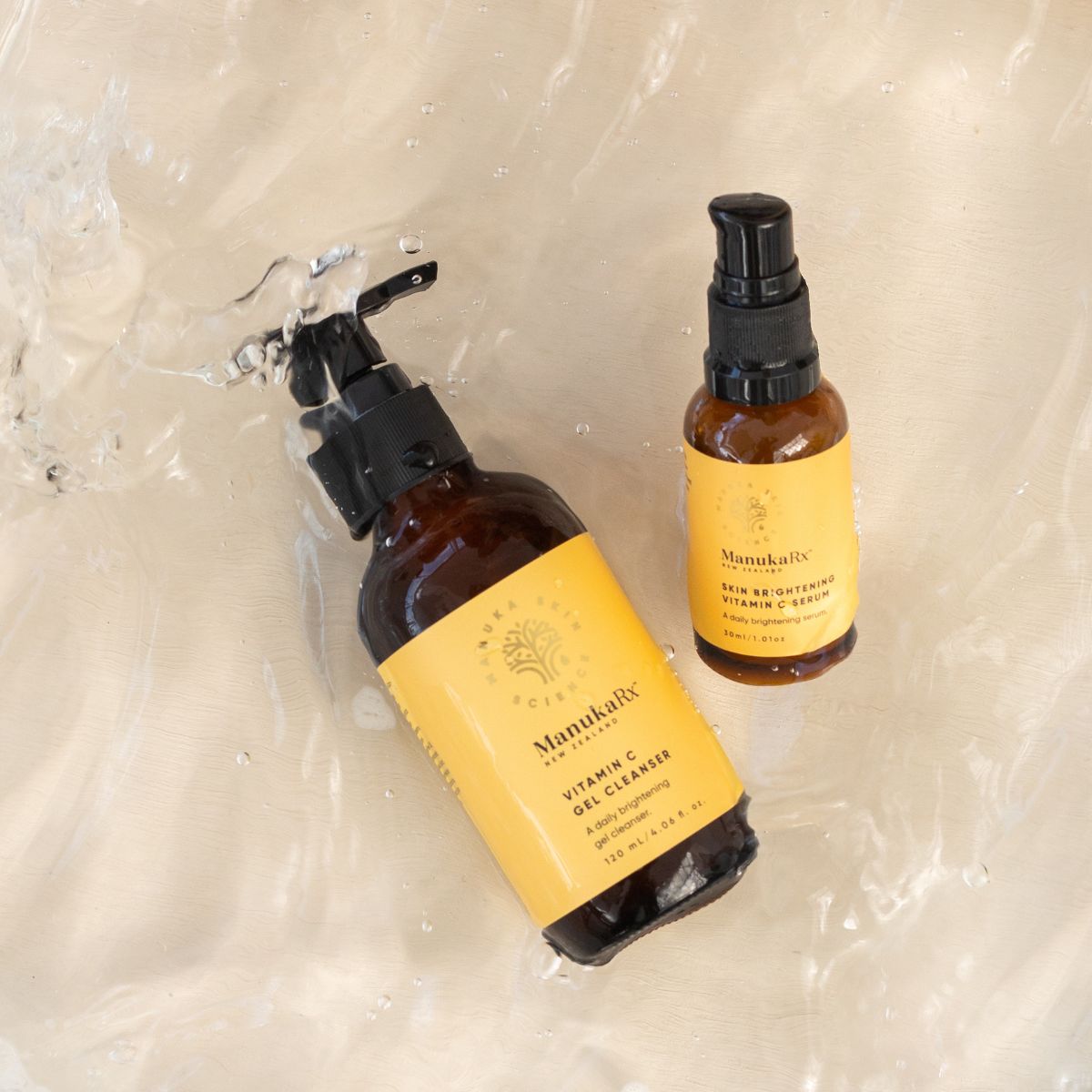 ManukaRx Vitamin C Gel Cleanser and Skin Brightening Vitamin C Serum lying in water