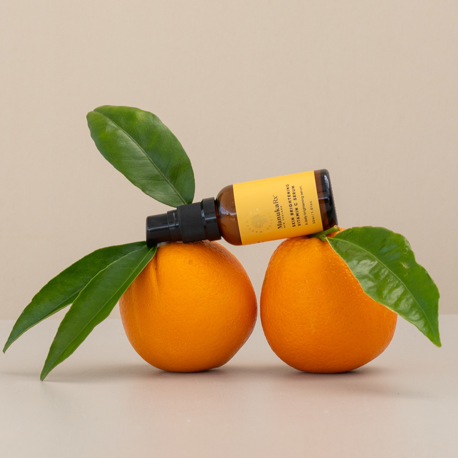 ManukaRx Skin Brightening Vitamin C Serum on oranges